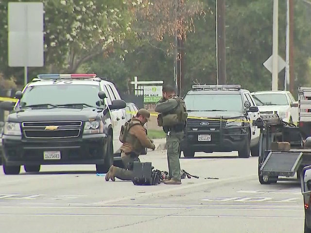 California officer dead, another wounded as standoff continues