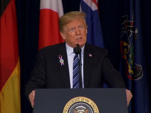 Trump pays sober tribute to 9/11 after Russia tweets, fist pumps